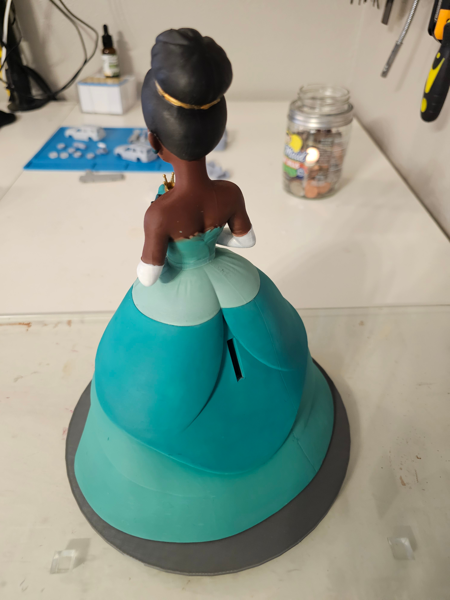 Custom character piggy bank showing coin slot on the back