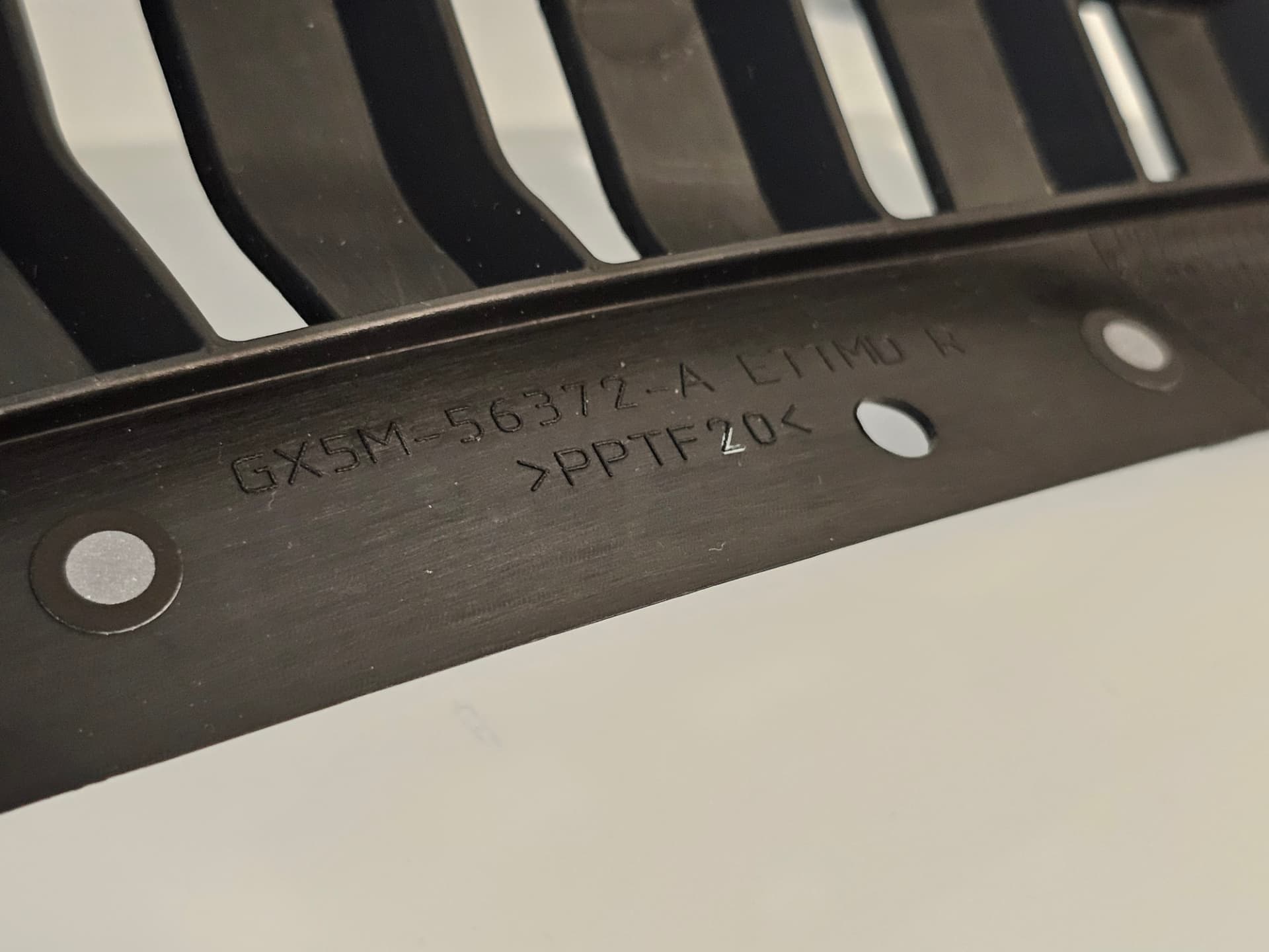 Close-up of the GX5M-56372-A part number marking on the original Jaguar F-Type SVR vent grille