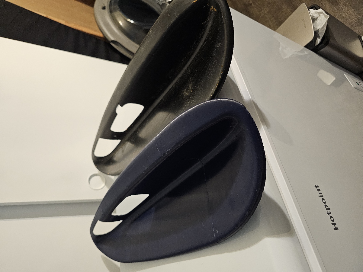 New 3D-printed blue Dodge Ram armrest next to the worn original black armrest
