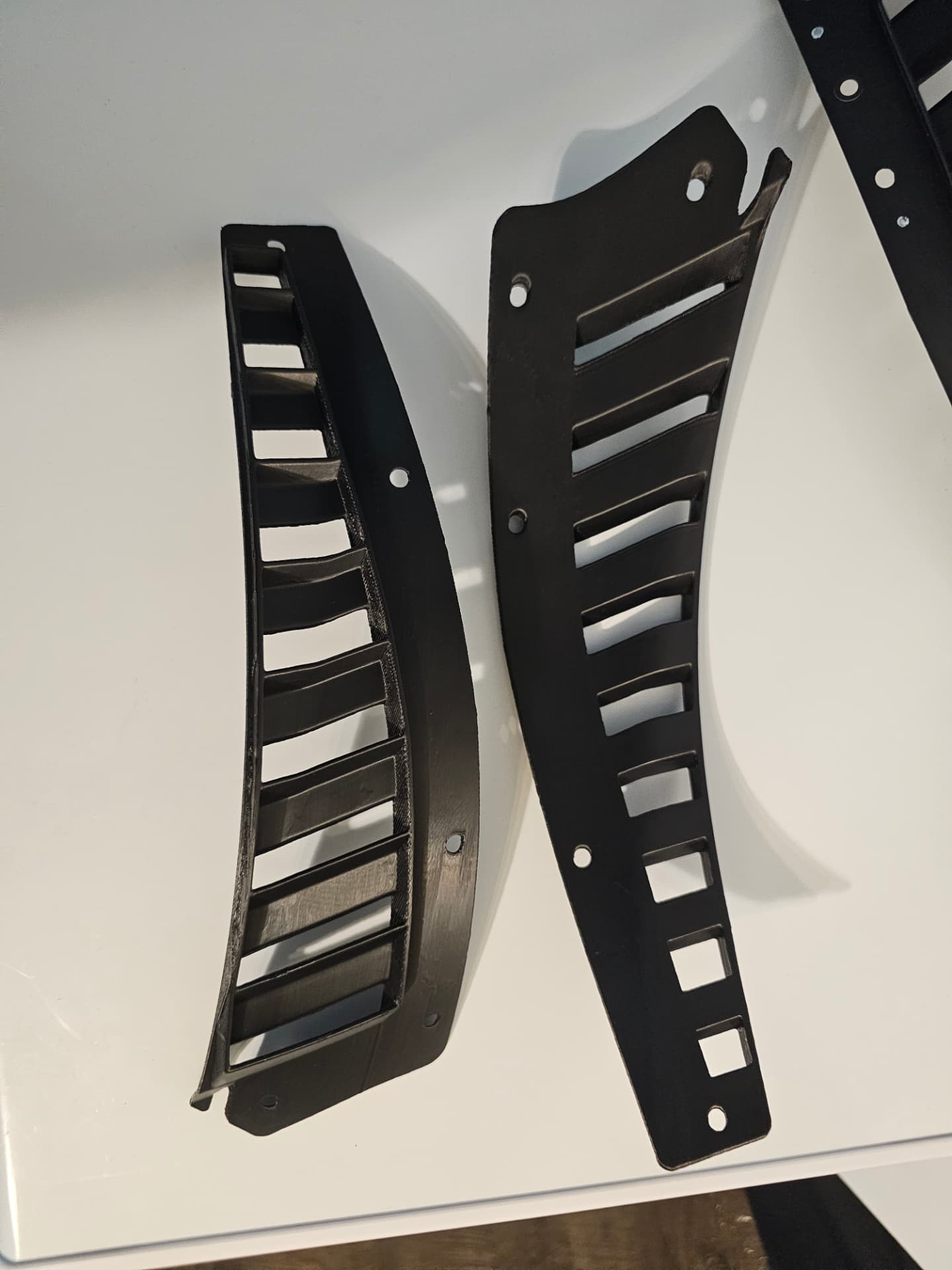 Pair of Jaguar F-Type SVR hood vent grille reproductions showing front and back detail